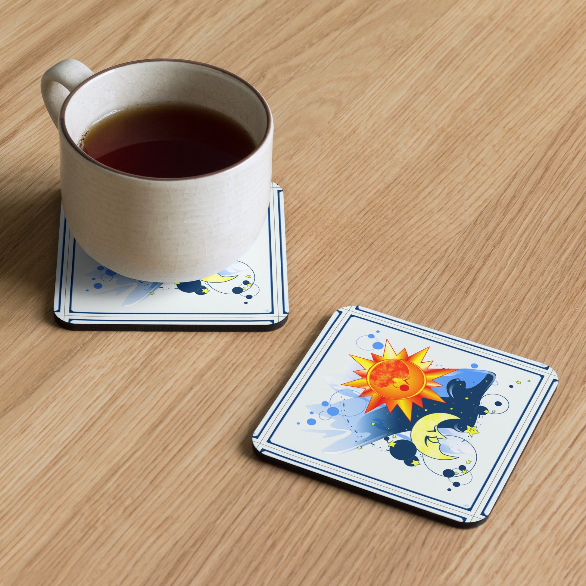 Cup of tea on a coaster with a sun, moon and stars design on a wooden table