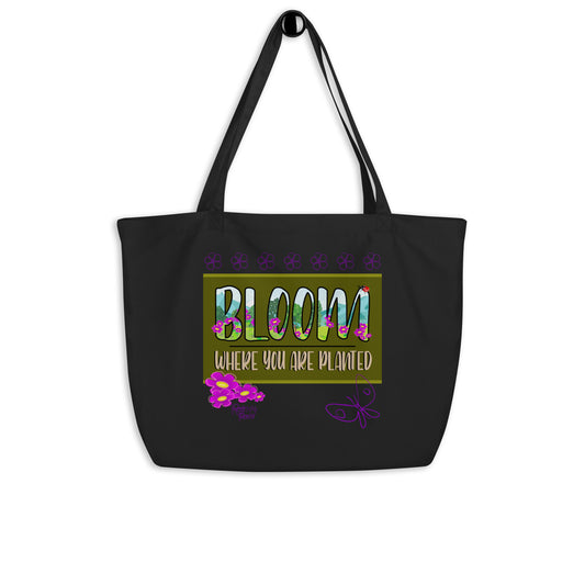 Black tote bag with 'Bloom Where You Are Planted' text and floral design on a white background.