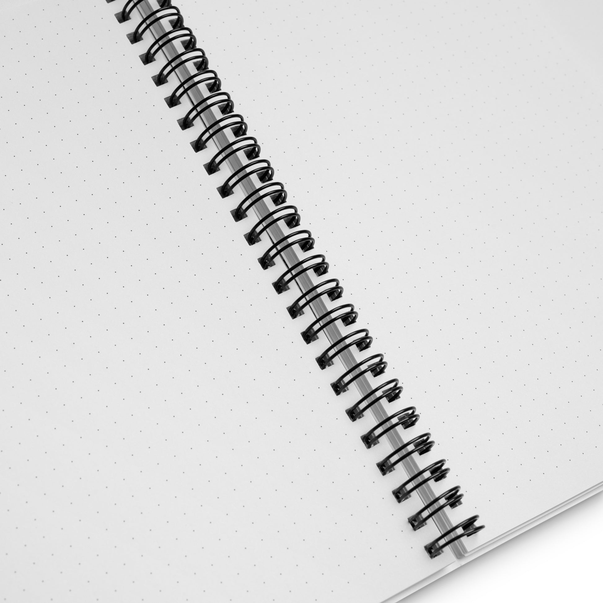Spiral-bound dotted notebook with a white background