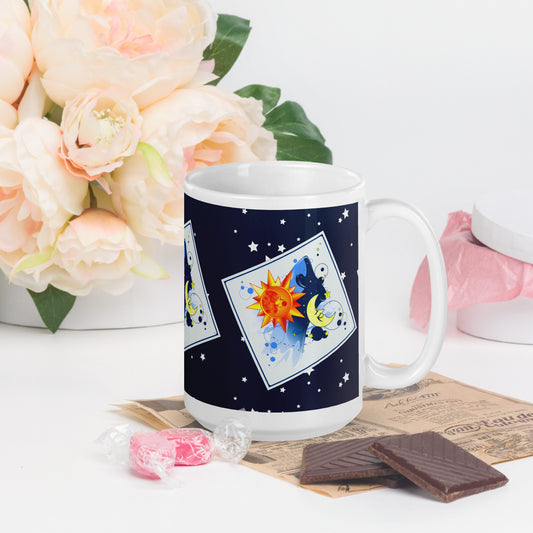 Mug with a sun and moon design on a table with flowers and chocolate