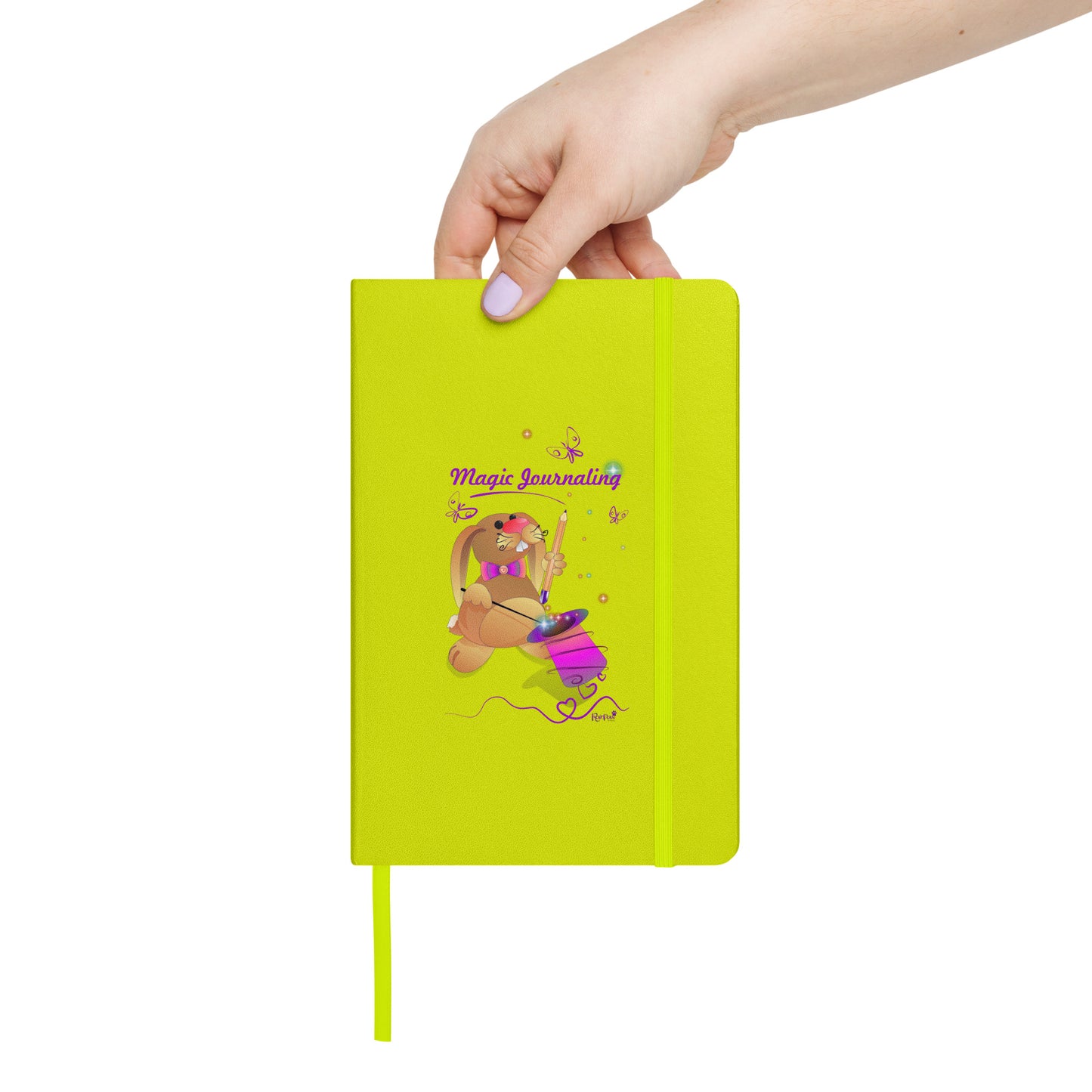 Lime-green notebook held by a hand on a white background. - The cover features a bunny holding a magic wand and a pencil pulled from its top hat, surrounded by butterflies, colourful stars, and hearts, giving the journal an enchanting feel. The words "Magic Journaling" are written on the cover.
