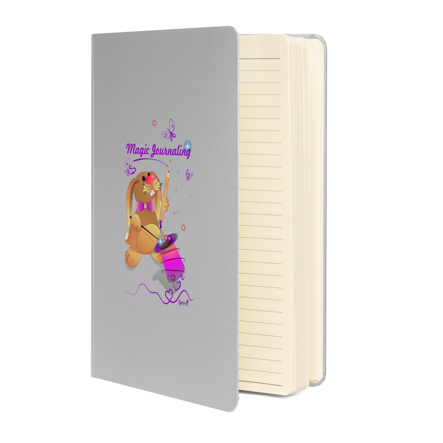 Silver notebook on a white background. The cover features a bunny holding a magic wand and a pencil pulled from its top hat, surrounded by butterflies, colourful stars, and hearts, giving the journal an enchanting feel. The words "Magic Journaling" are written on the cover.