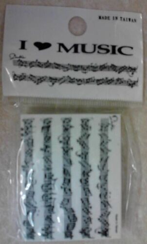 Music-themed white erase and black printed notation in a clear package.