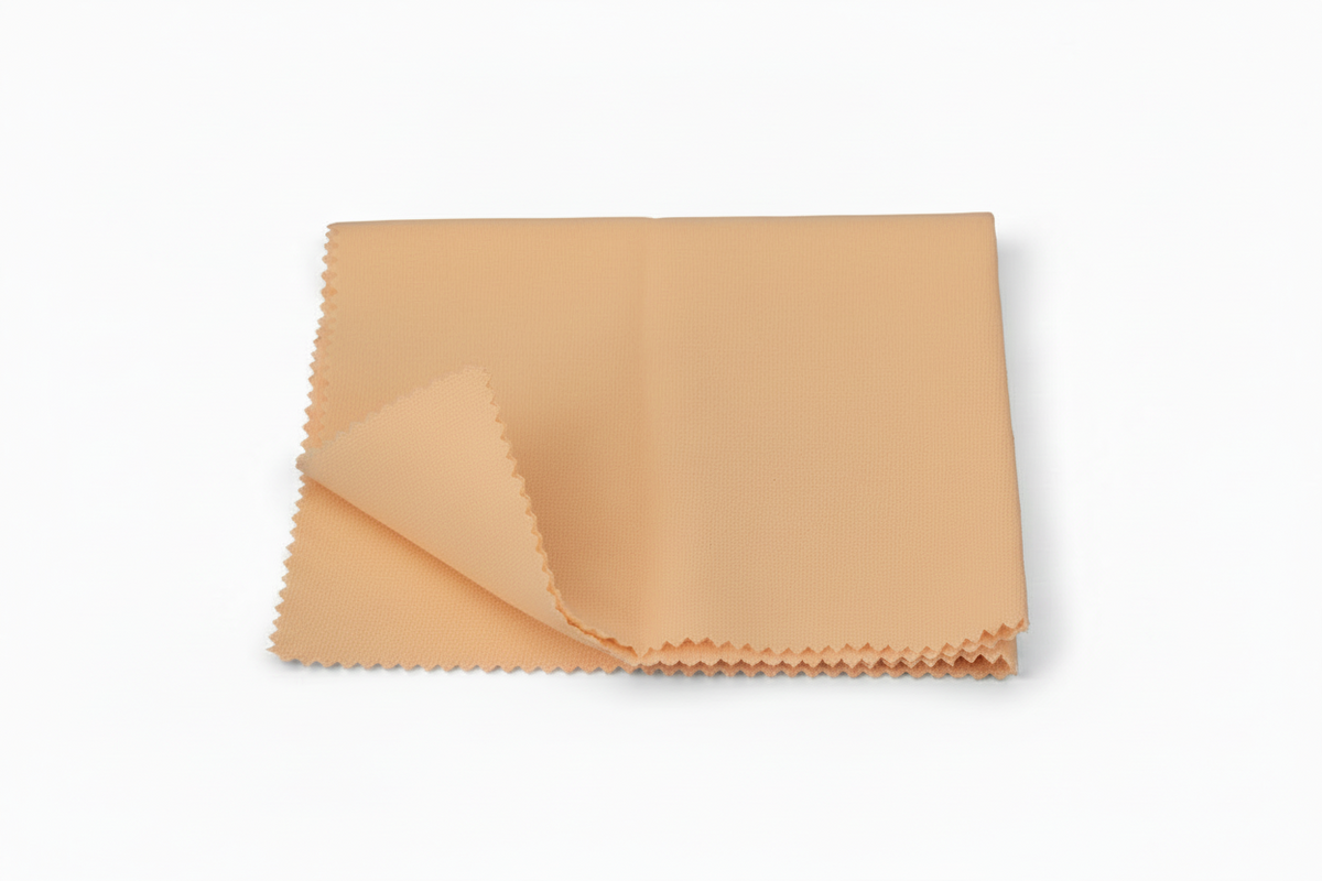 A folded beige microfiber cloth with serrated edges, shown on a clean white background.
