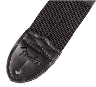 detail of the leather end with hole for the strap button and fender's branding 