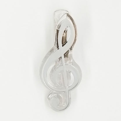 Silver treble clef paper clip on a white background