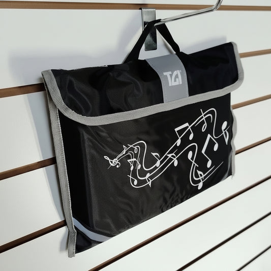 A black and grey roll-top bag with a white graphic hanging from a metal hook on a slatwall display.