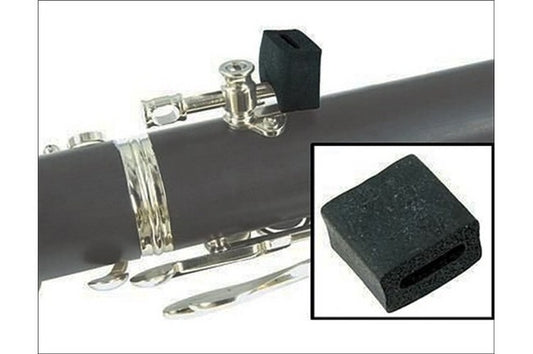 In this picture a foam rectangular block with a fissure in the middle slides over the thumb rest of a clarinet