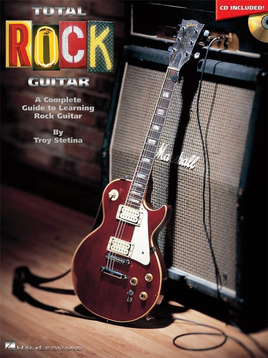 Book titled 'Total Rock Guitar' with a guitar and amplifier on a wooden floor.