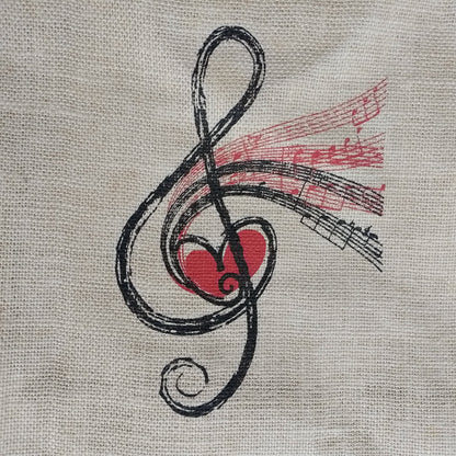 A close-up of a beige woven fabric surface featuring a printed abstract design in black and red, with a heart-like red shape and flowing black lines.