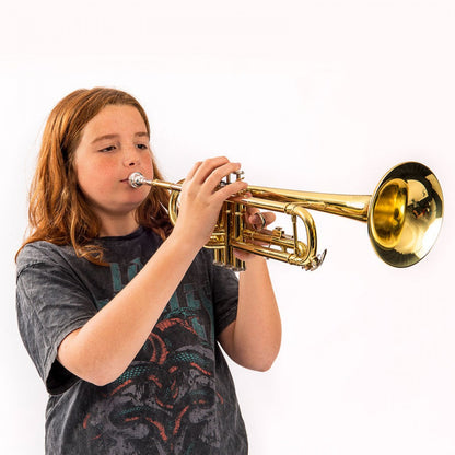 Child playing a gold trumpet on a white background