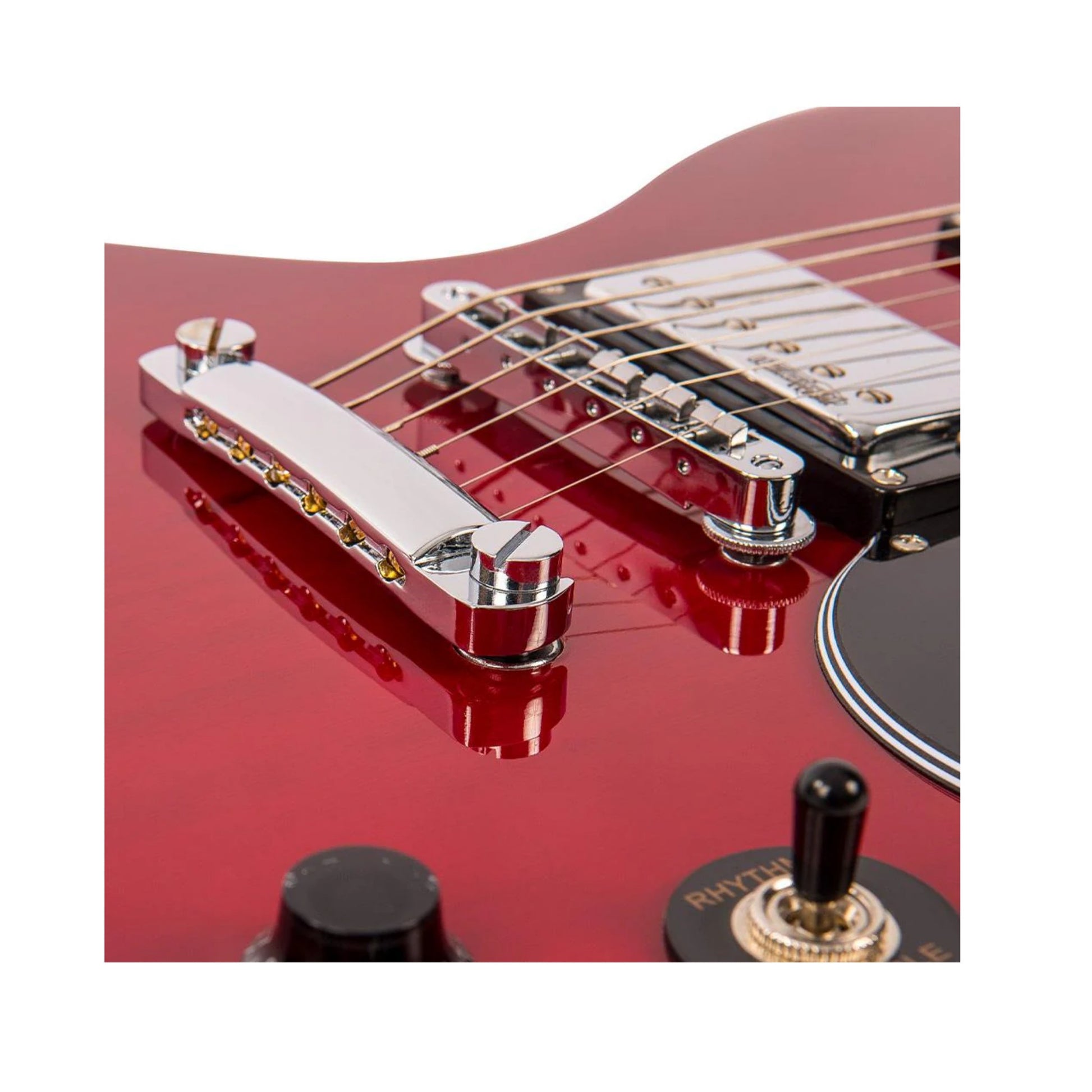 Close-up of a red electric guitar with focus on the bridge and control knobs.