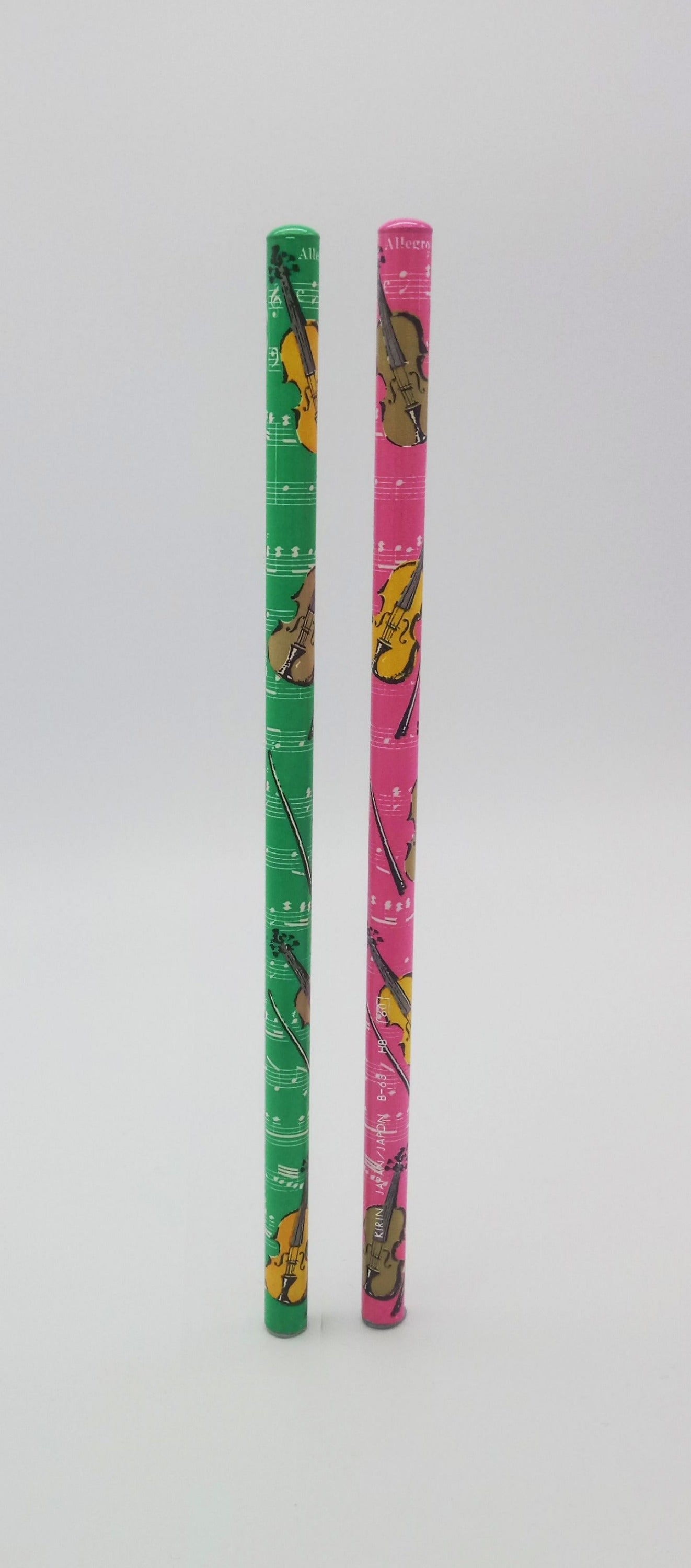 Two colorful pencils with violin/viola designs on a white background