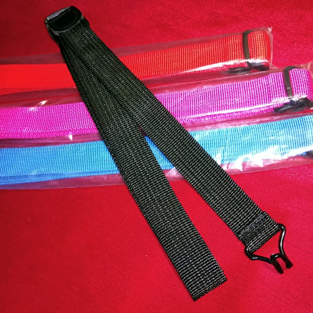 Black webbing strap with a clip on a red background