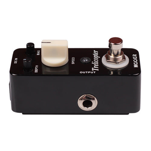 Black guitar effects pedal with control knobs and footswitch on a white background