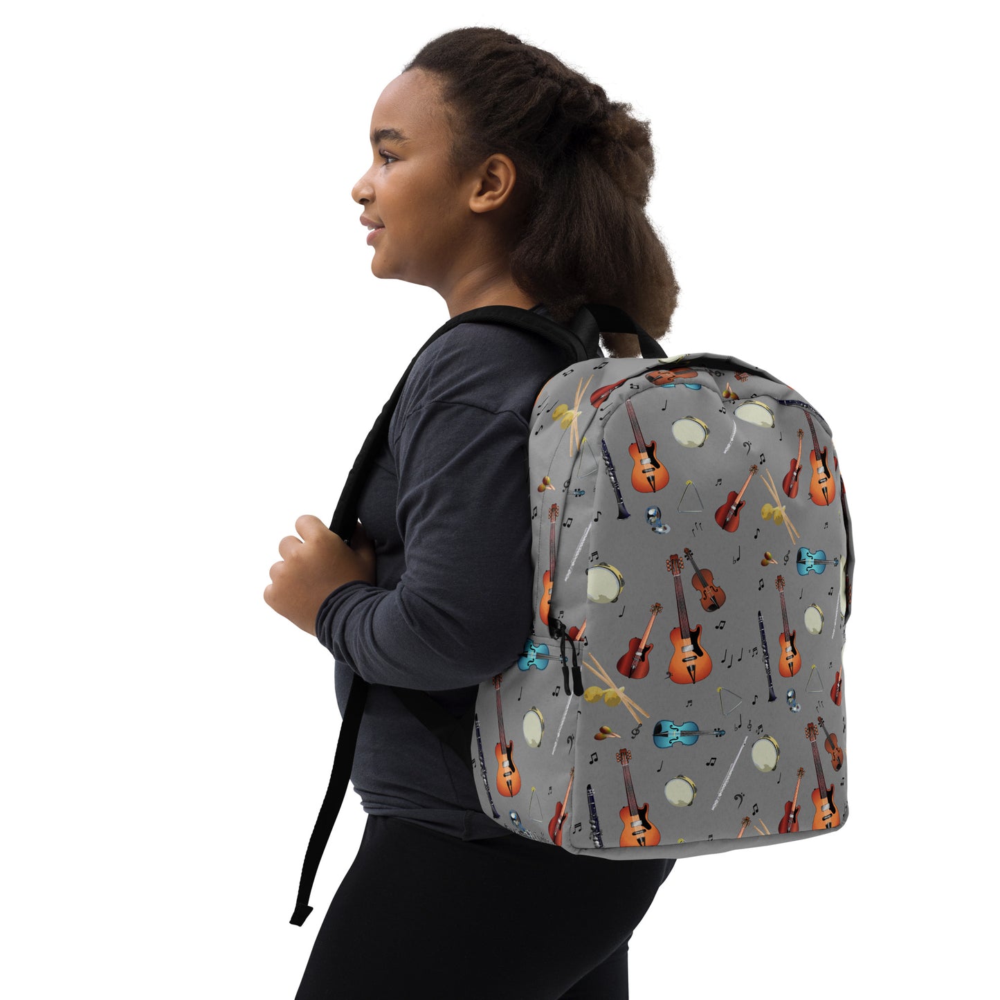 A girl wearing a grey backpack with musical instrument pattern 