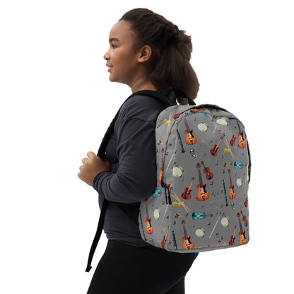 A girl wearing a grey backpack with musical instrument pattern 