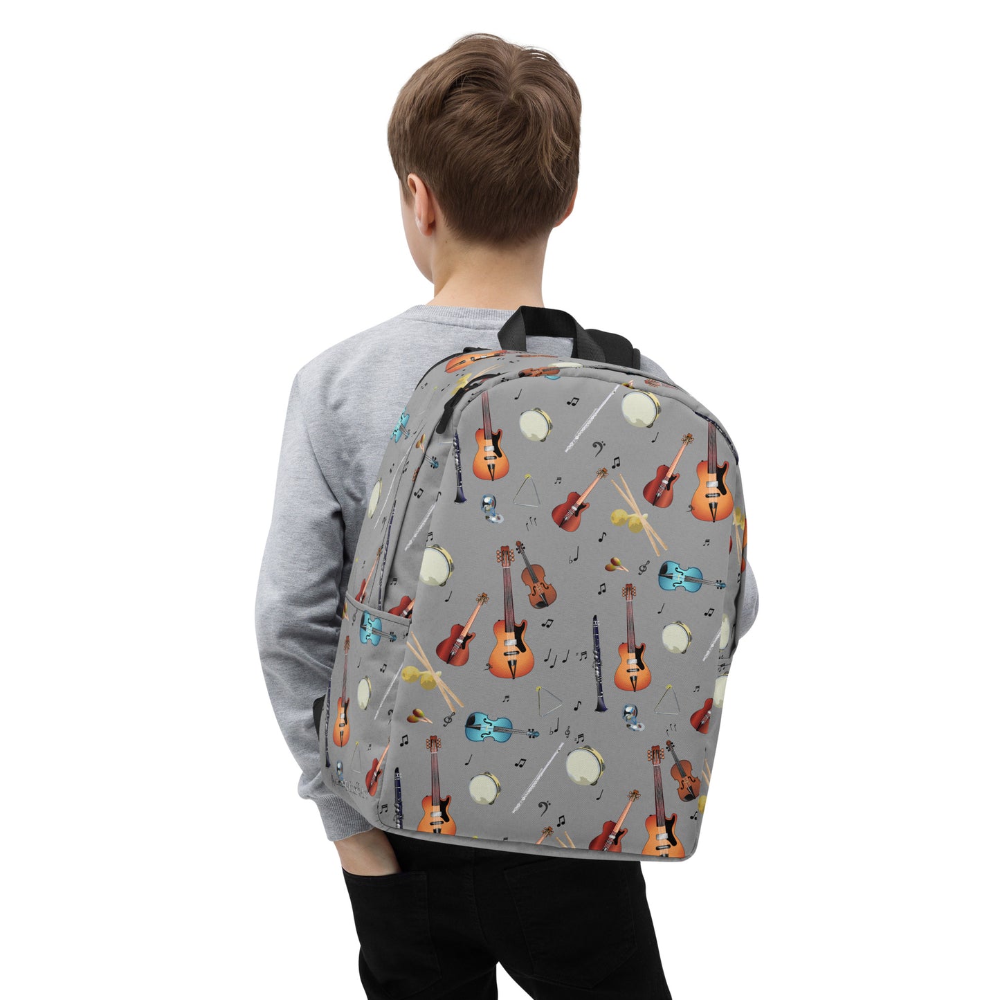 Child wearing a grey backpack with musical instrument pattern 