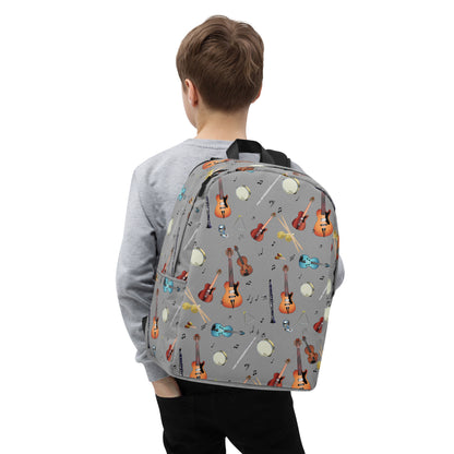 Child wearing a grey backpack with musical instrument pattern 