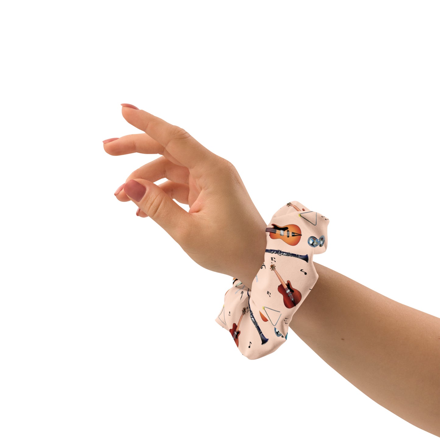 Hand wearing a patterned scrunchie on a white background