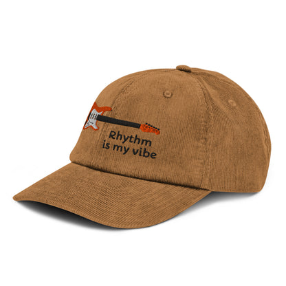 Brown cap with 'Rhythm is my vibe' text and musical notes on a white background