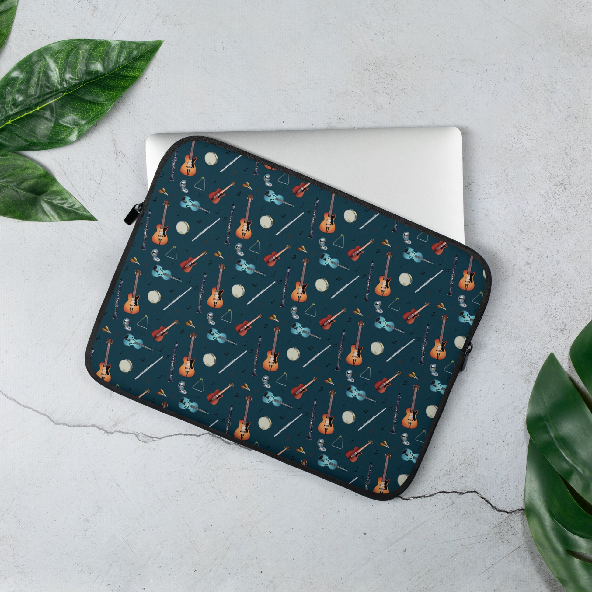 Laptop sleeve with musical notes, guitar, bass guitar, flute, tambourine, triangle and clarinet  pattern on a blue/green background