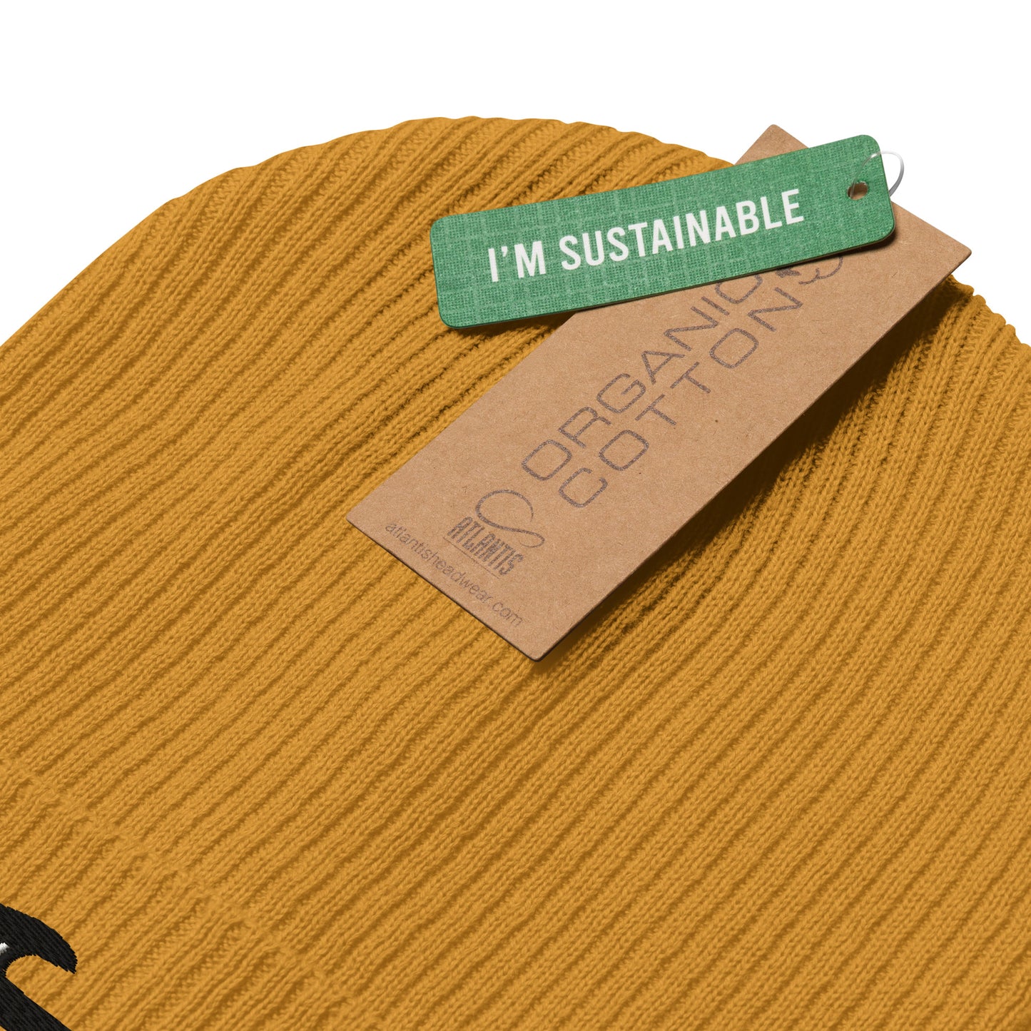 Mustard yellow fabric with a 'I'm Sustainable' tag on a white background