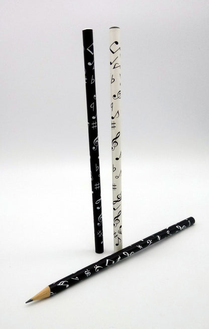 An image of three black and white pencils with decorative designs on a white background