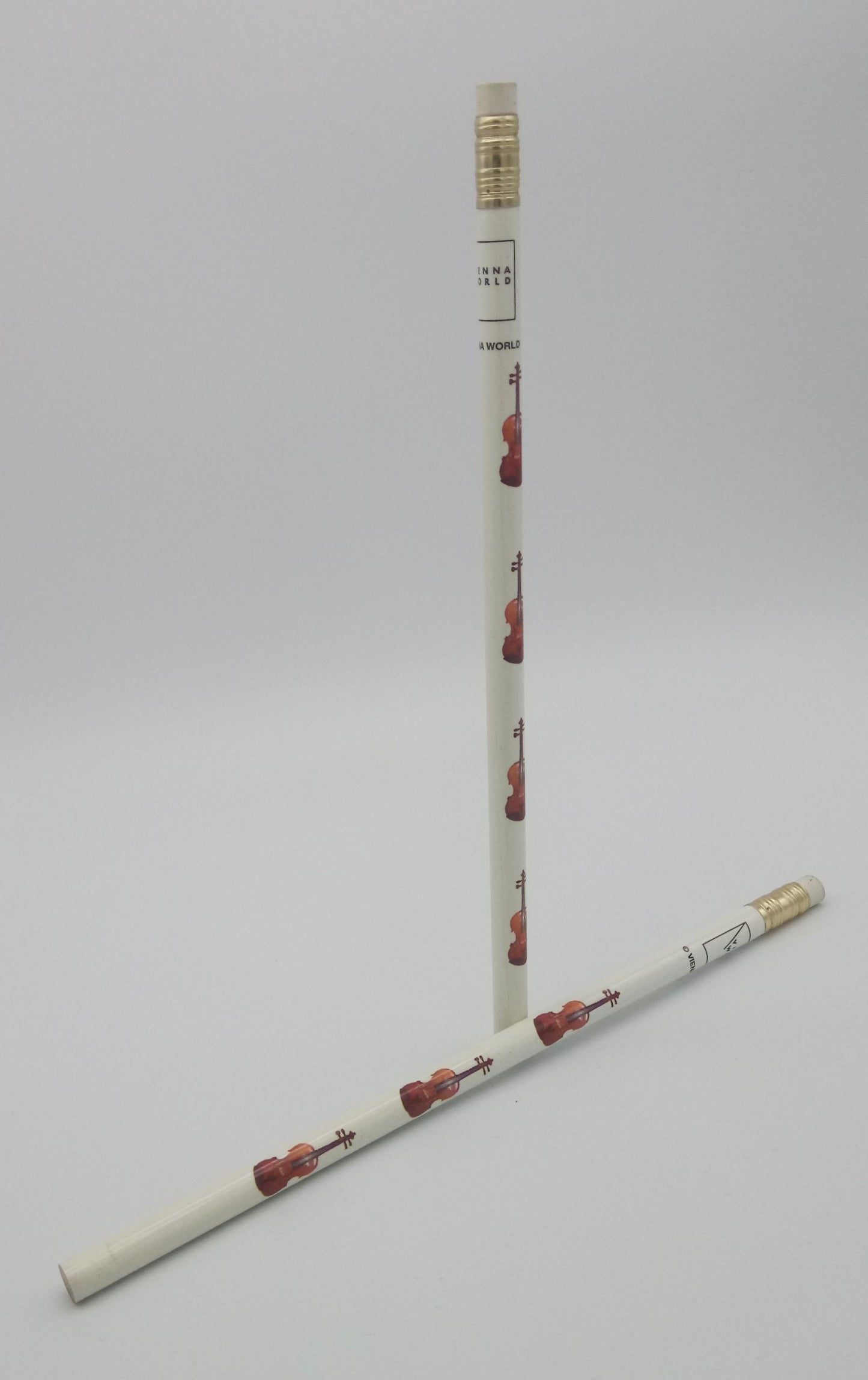 Two pencils with decorative designs of violins/violas  on a light grey background