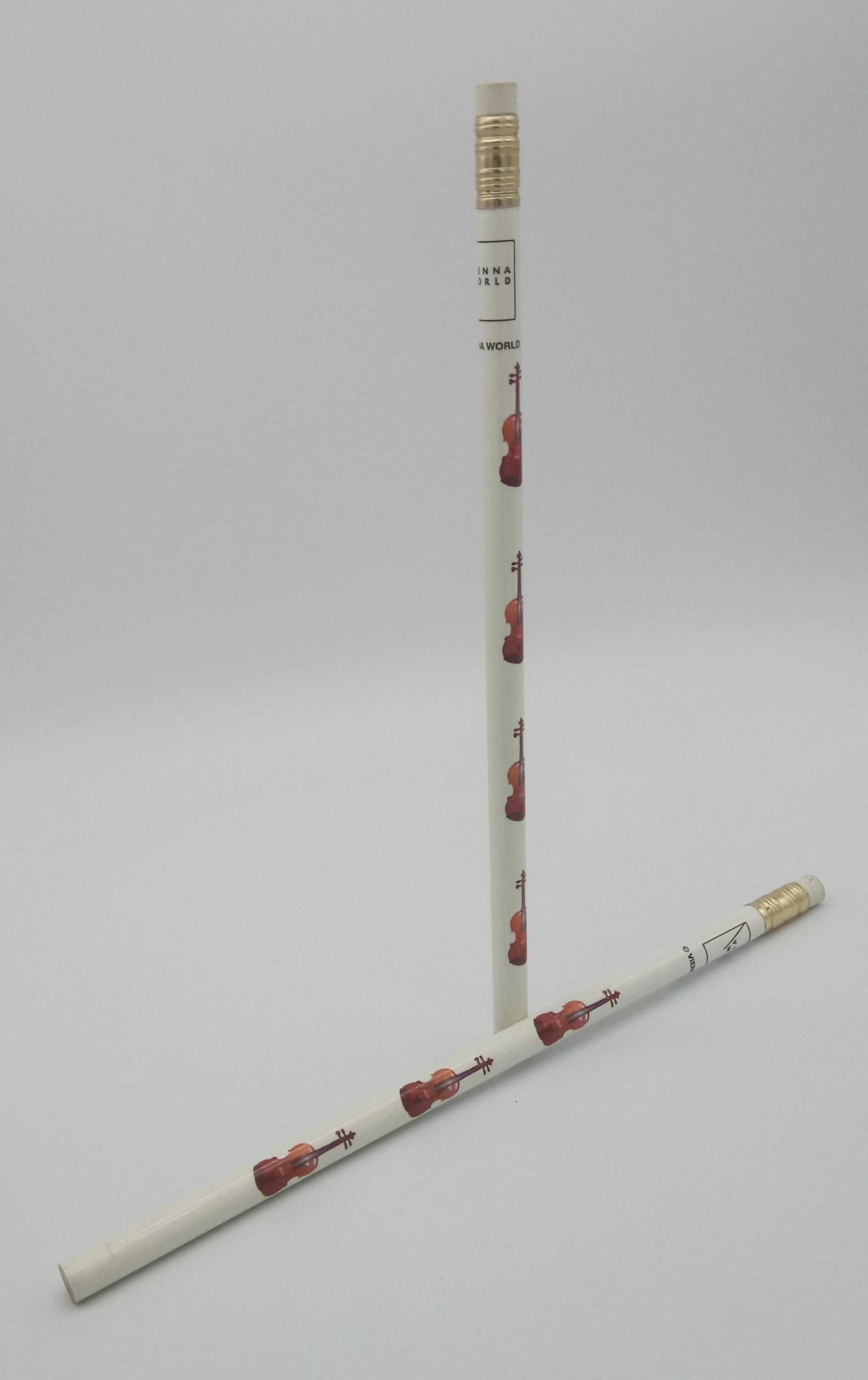 Two pencils with decorative designs of violins/violas  on a light grey background